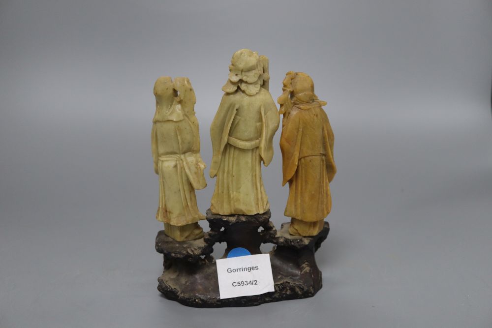 Three Chinese soapstone carvings of immortals, on base, height 19cm